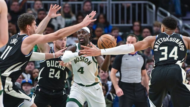 Boston Celtics guard Jrue Holiday (4) gets pressure from Milwaukee Bucks center Brook Lopez (11), guard Pat Connaughton (24) and forward Giannis Antetokounmpo (34) 